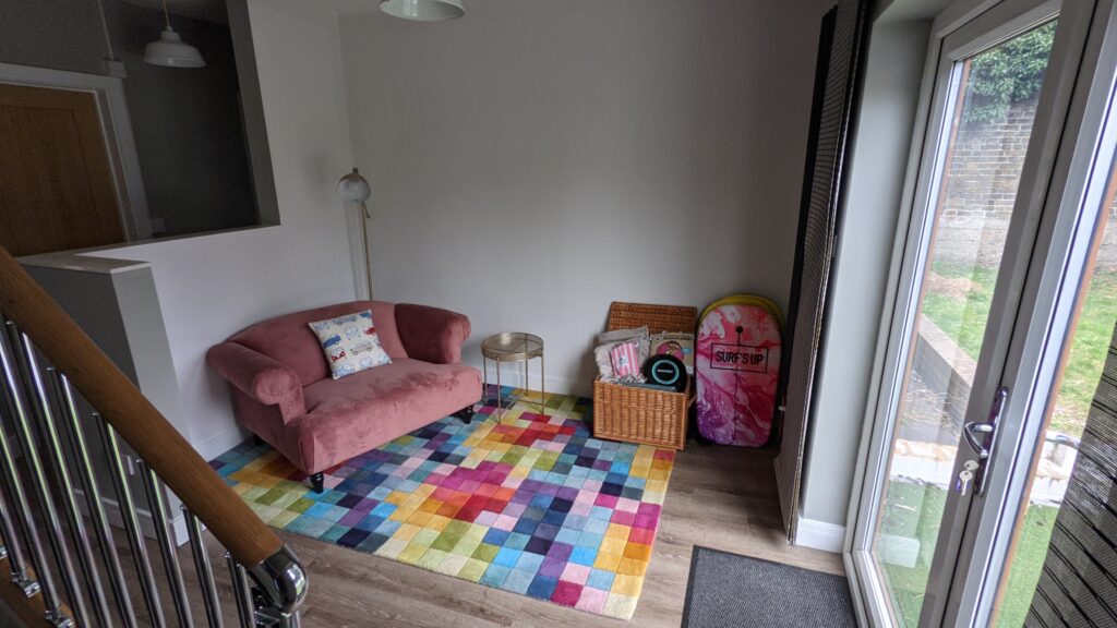 Love seat and pixel rug in AirBnB Margate.
